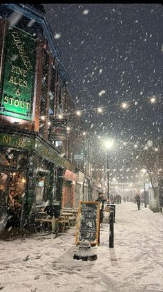 a snowy street with people walking on it