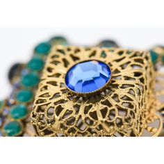 This is part of Chairish’s Costume Jewelry assortment.  This stunning vintage hallmarked Hattie Carnegie pin/ brooch can be angled or placed straight on. The gilt metal filigree work is surrounded by blue and green glass stones. Signed Hattie Carnegie on the back. This is a rare brooch and we have the matching dangle earrings to it that we think must be purchased together. Both of these pieces have been in our archives now for over 35 years.From the 60's. The combination of colors are beautiful. Formal Blue Gemstone Brooch, Formal Blue Gemstone Brooches, Blue Victorian Brooch For Formal Occasions, Victorian Blue Brooch For Formal Occasions, Blue Victorian Brooches For Formal Occasions, Elegant Blue Jeweled Brooches, Elegant Blue Gemstone Brooch, Elegant Blue Gemstone Brooches, Vintage Sapphire Brooches For Gifts