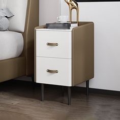 a nightstand with a lamp on top of it next to a bed