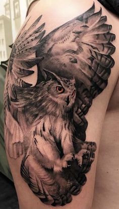 an owl and bird tattoo on the left arm is shown in black and grey colors