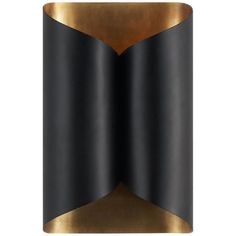 a black and gold wall light with an unusual design on the front, which is made out of metal