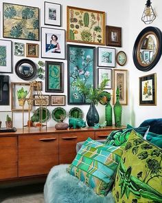 a living room filled with lots of pictures on the wall