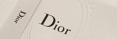 a close up view of the dior logo on a pair of white tennis shoes