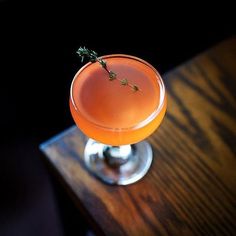 a drink sitting on top of a wooden table