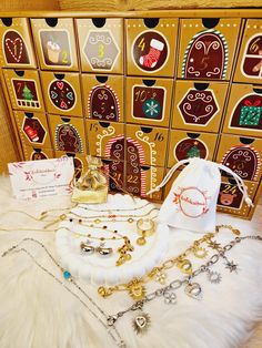 several different types of jewelry on display in front of a wooden cabinet with christmas decorations