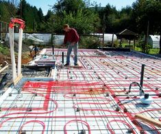 a man standing on top of a metal slab with red piping in the middle