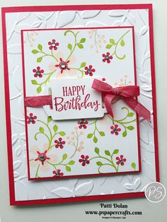 a happy birthday card with red ribbon and flowers on the front, featuring a tag that says happy birthday