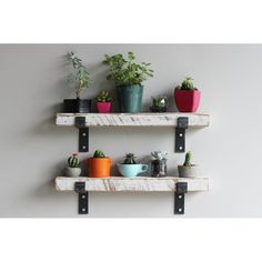 two wooden shelves holding potted plants on top of each other with black metal brackets