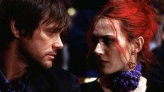 a man and woman with red hair looking at each other