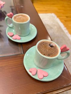 two cups of hot chocolate with hearts on them