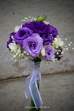 purple and white flowers are in a vase