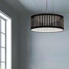 a light fixture hanging from the ceiling in a room with white walls and flooring