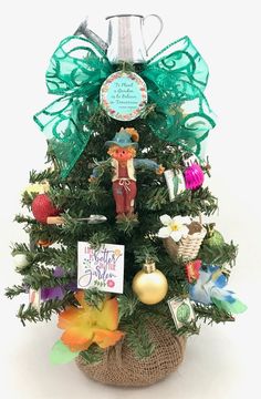 a small christmas tree decorated with ornaments and greetings for someone's special day