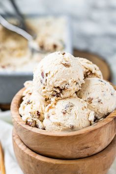 a wooden bowl filled with ice cream on top of a table