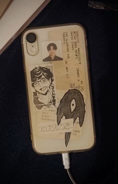 an iphone case with some drawings on it and a cord plugged into the phone