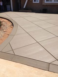 a concrete patio in front of a house