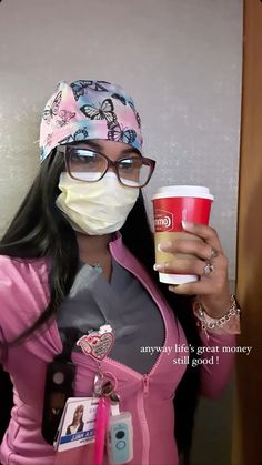 a woman wearing a face mask and holding a cup