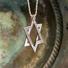 This Exceptional Interlocking Star of David Pendant is an extraordinary silver masterpiece combining spiritual significance and unique design.  This captivating pendant, crafted with meticulous detail, features two interlocking parts forming the sacred Star of David and is adorned with the timeless Priestly Blessing. The pendant proudly displays the Priestly Blessing:  "May God bless and guard you. May God show you favor and be gracious to you. May God show you kindness and grant you peace." The Spiritual White Gold Necklaces With Polished Finish, Spiritual Engraved White Gold Jewelry, Engraved Spiritual White Gold Jewelry, Engraved White Gold Spiritual Jewelry, Spiritual Silver Necklace With Engraving Option, Luxury Silver Necklace For Ceremonial Occasions, Sterling Silver Star Of David Necklace With Polished Finish, Symbolic Engraved Jewelry For Blessing, Engraved White Gold Amulet Necklace