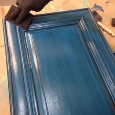 a close up of a blue door being painted