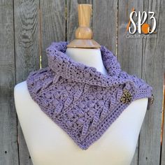 a purple crocheted cowl on top of a white mannequin