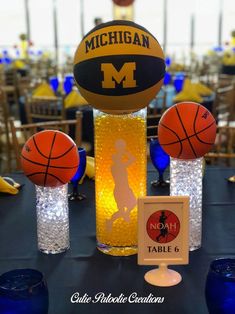 there is a table with basketballs and other items on it, including a glass vase