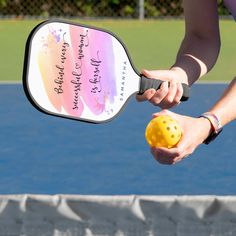 a person holding a tennis racquet with a ball in it's hand