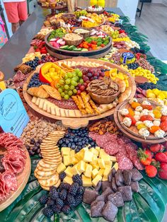 a table filled with lots of different types of cheeses and meats on it