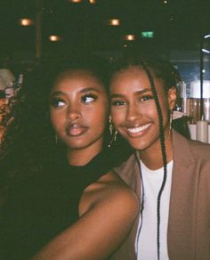 two young women are posing for the camera