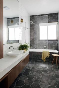 a bathroom with grey hexagonal tiles on the floor