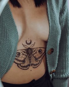 a woman with a butterfly tattoo on her stomach