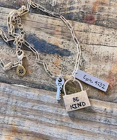 Personalized Mixed Metal Hand-stamped necklace with 3 stamped charms. "And be kind and compassionate to one another, forgiving one another, just as God also forgave you in Christ." Ephesians 4:32 HCSB This necklace design includes 3 hand-stamped charms:  Gold plated padlock charm hand-stamped with the words "Be Kind", stainless steel silver charm stamped with scripture reference "Eph 4:32", and a tiny silver key charm hand-stamped with a heart.   Choose this necklace or design your own by submitting your word(s)and scripture reference in the "Note to Seller" section when placing your order. Each piece is hand designed with slight imperfections and no two are exactly alike...just as God designed us one by one.  We can praise God as we see these imperfections as a reminder that through the b Inspirational Pendant Charm Necklaces For Everyday, Everyday Spiritual Nickel-free Charm Necklaces, Nickel-free Spiritual Charm Necklaces For Everyday, Adjustable Inspirational Nickel-free Charm Necklace, Inspirational Adjustable Nickel-free Charm Necklaces, Everyday Meaningful Nickel-free Charm Necklaces, Word Necklace, Ephesians 4, Silver Key