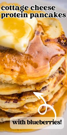 a stack of pancakes with butter and syrup on top that says cottage cheese protein pancakes with blueberries