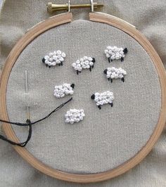 a close up of a cross stitch with sheep on it