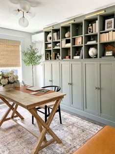 an office with bookshelves, desk and chairs in front of the bookcase