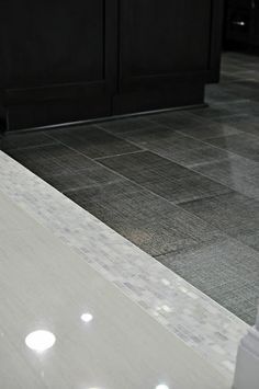 a white counter top sitting on top of a tiled floor