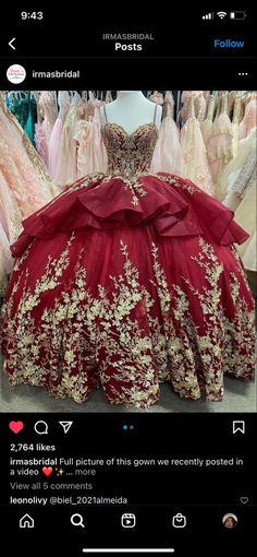 a red and gold dress on display in a store with lots of dresses behind it