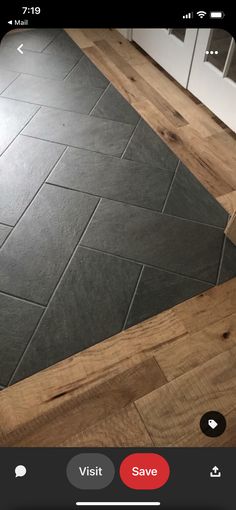 the floor is made from wood and has black slate tiles on it, which are very similar to each other