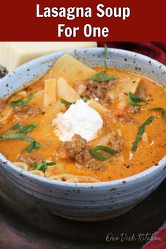 a bowl of lasagna soup with sour cream on top and the title overlay says lasagna soup for one