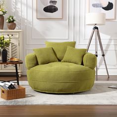 a living room with green furniture and pictures on the wall