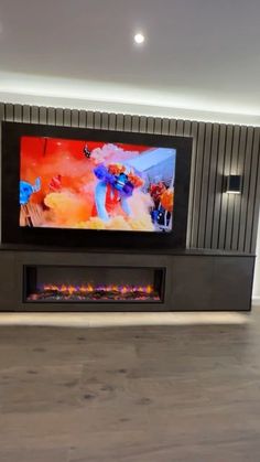 a flat screen tv mounted on the wall in a living room with wood flooring