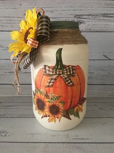 a mason jar decorated with sunflowers and plaid ribbon