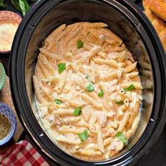 a crock pot filled with pasta and sauce