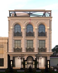 a large white building with lots of windows on the top floor and an awning above it