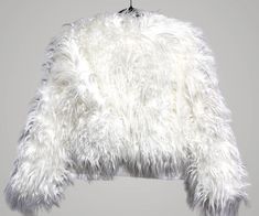 Size Large I have Available a Sold Out Hot & Delicious Brand for Dolls Kill Jacket that is a must-have for any fashion-forward woman's wardrobe. Featuring an Ivory faux Long fur outer shell, long sleeves, Lined Interior, Collarless, and Large Hook & Eye closures. Hand Wash/ Air Dry. Gorgeous Fluffy jacket that is the perfect addition to any outfit. New With Tag Approximate Measurements back to bottom 19” top of neck to end of arm 29” waist 21” chest 22” I am selling my well cared for Collection Chic White Fluffy Outerwear, White Faux Fur Outerwear With Feather Trim, White Faux Fur Party Outerwear, White Faux Fur Outerwear For Party, White Fluffy Long Sleeve Fur Coat, White Faux Fur Coat For Spring, Black Fur Jacket Outfit, Fur Shirt, Shaggy Fur Coat