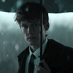 a man holding an umbrella in the rain