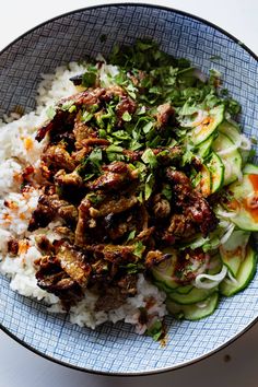 a bowl filled with rice, meat and veggies