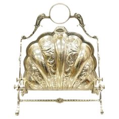 an ornate metal headboard with three heads and two hands on the back of it