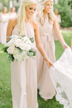 the bridesmaids are getting ready to walk down the aisle with their bouquets