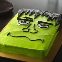 a cake that looks like the face of a monster on top of a cutting board