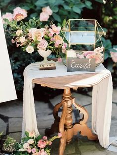 a table with flowers and cards on it